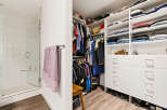 Step into this spacious walk-in closet, featuring ample shelving and drawers for organized storage.