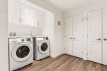 This laundry room features a stacked Samsung washer and dryer set, offering ample space for your laundry needs.