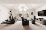 This spacious room offers a versatile layout, perfect for both fitness and entertainment.