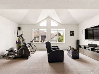 This spacious room offers a versatile layout, perfect for both fitness and entertainment.