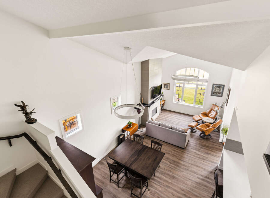 Experience modern living in this spacious open-concept home featuring a soaring vaulted ceiling and abundant natural light.