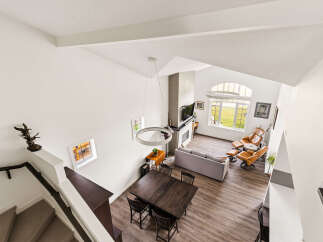 Experience modern living in this spacious open-concept home featuring a soaring vaulted ceiling and abundant natural light.