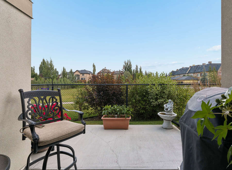 Enjoy outdoor living on this charming patio, complete with a comfortable seating area and a covered grill, perfect for summer barbecues.