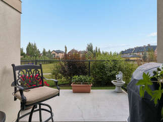 Enjoy outdoor living on this charming patio, complete with a comfortable seating area and a covered grill, perfect for summer barbecues.