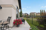 Enjoy outdoor living on this charming patio, complete with comfortable seating and vibrant floral arrangements.