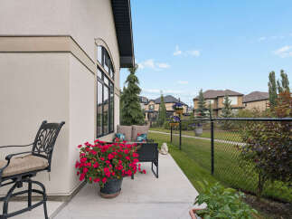 Enjoy outdoor living on this charming patio, complete with comfortable seating and vibrant floral arrangements.