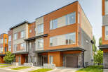 Discover modern living in these stunning townhomes featuring a striking combination of warm wood siding and sleek stone accents.