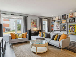 Step into this inviting living room, featuring a spacious sectional sofa adorned with vibrant accent pillows, perfect for cozy gatherings.