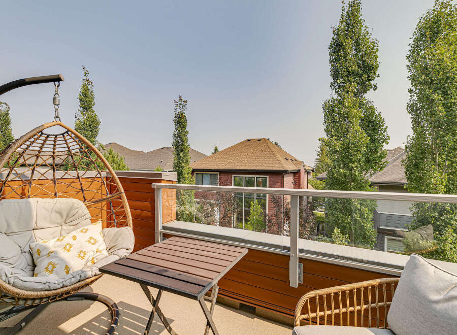 Enjoy your morning coffee or evening relaxation on this charming balcony, complete with a comfortable hanging chair and a small table.