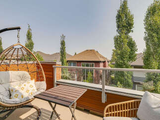 Enjoy your morning coffee or evening relaxation on this charming balcony, complete with a comfortable hanging chair and a small table.