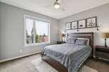 This inviting bedroom features a comfortable queen-sized bed with a stylish grey patterned comforter, complemented by two matching pillows.