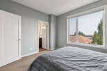 Experience comfort and style in this inviting bedroom, featuring a plush grey comforter on a spacious bed.