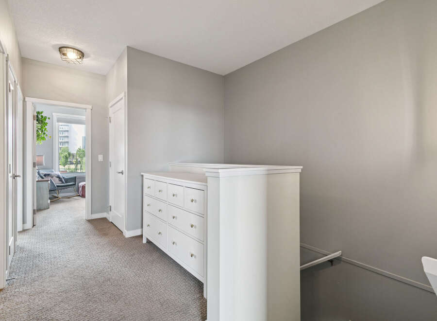 Discover this charming hallway featuring a white dresser with multiple drawers, perfect for storage.