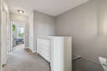 Discover this charming hallway featuring a white dresser with multiple drawers, perfect for storage.