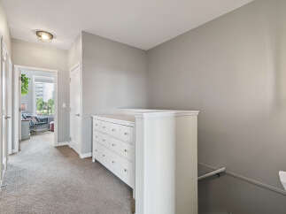 Discover this charming hallway featuring a white dresser with multiple drawers, perfect for storage.