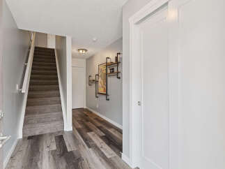 Step into this inviting entryway featuring a carpeted staircase leading to the upper level.