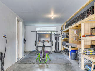 Transform this versatile garage space into your personal home gym or a functional workshop.