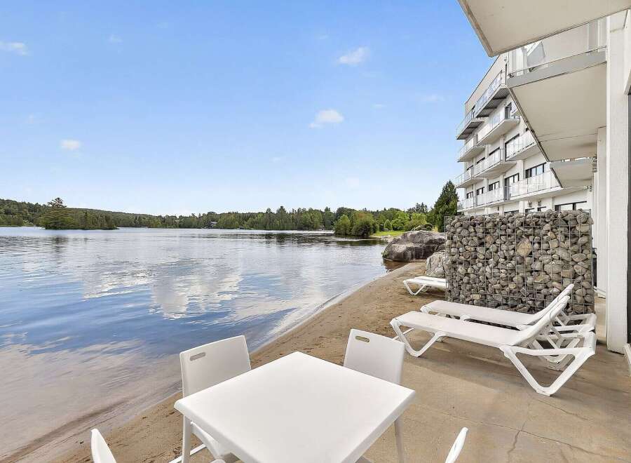 Enjoy lakeside living with this stunning property featuring a private beach area and direct water access.