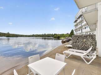 Enjoy lakeside living with this stunning property featuring a private beach area and direct water access.