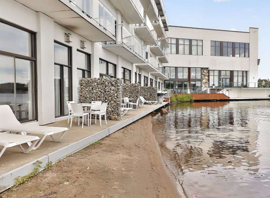 Experience modern waterfront living in this stunning property featuring a private patio with direct access to the water.