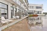 Experience modern waterfront living in this stunning property featuring a private patio with direct access to the water.