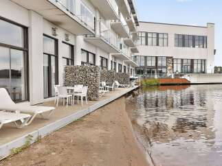 Experience modern waterfront living in this stunning property featuring a private patio with direct access to the water.