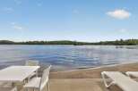 Enjoy serene lakefront living with this stunning property, featuring a private sandy beach perfect for relaxation and recreation.
