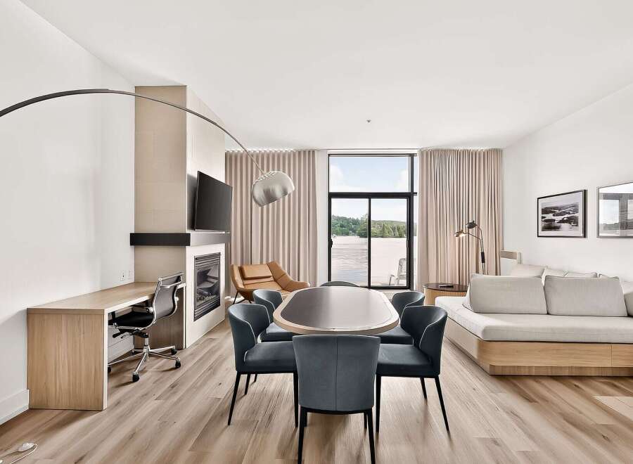 Experience modern living in this spacious suite, featuring a dedicated workspace with a built-in desk and ergonomic chair.