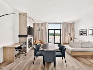 Experience modern living in this spacious suite, featuring a dedicated workspace with a built-in desk and ergonomic chair.