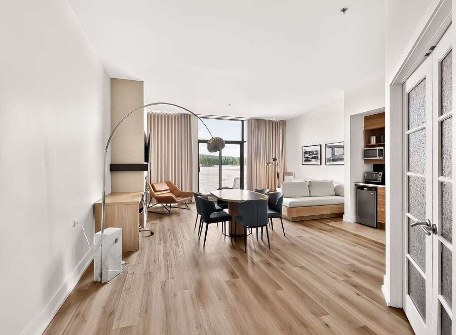 Experience modern living in this spacious studio apartment, featuring a well-appointed kitchenette with a microwave and mini-fridge.