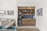 This stylish studio apartment features a compact kitchenette equipped with a microwave, toaster oven, and mini-fridge, perfect for preparing light meals.