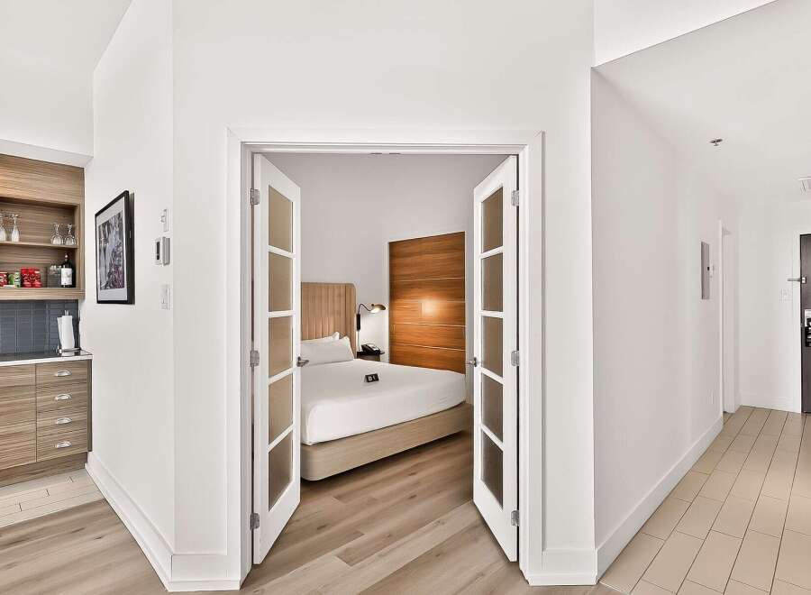 Discover modern living in this stylish studio apartment, featuring a convenient kitchenette with ample cabinet space and a chic tiled backsplash.