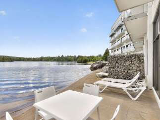 Enjoy lakeside living with this stunning property featuring a private beach and modern amenities.