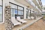 Enjoy waterfront living with this modern property featuring a spacious patio overlooking the water.