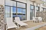 Enjoy stunning lake views from this modern patio, perfect for relaxation and outdoor dining.