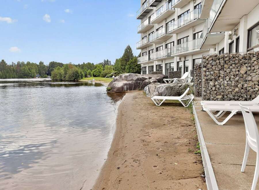 Enjoy lakeside living with this stunning property featuring a private beach and direct water access.