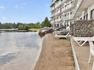 Enjoy lakeside living with this stunning property featuring a private beach and direct water access.
