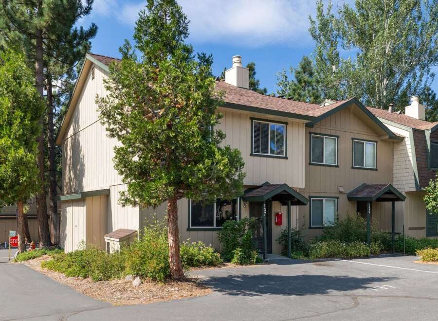 Discover this charming townhouse nestled amongst mature trees, offering a serene and private living experience.