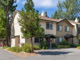Discover this charming townhouse nestled amongst mature trees, offering a serene and private living experience.