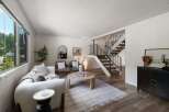 Discover this inviting living space featuring a plush white sofa and two comfortable armchairs, perfect for relaxation.