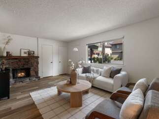 Cozy living room featuring a rustic stone fireplace, perfect for gathering on cool evenings.