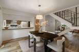 Experience modern living in this open-concept dining area, seamlessly connected to a functional kitchen with ample counter space and a breakfast bar.