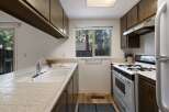 This charming kitchen features ample cabinet space and a functional layout.