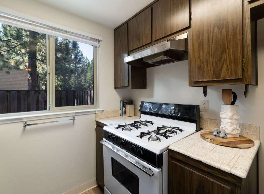 This charming kitchen features a gas range and ample cabinet space, perfect for home chefs.