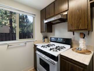 This charming kitchen features a gas range and ample cabinet space, perfect for home chefs.