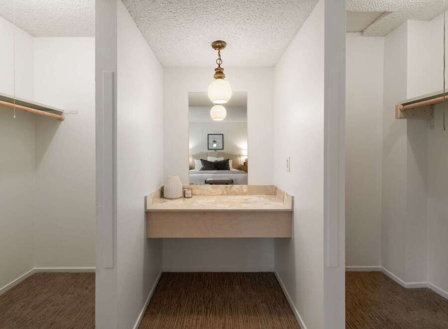 Discover a functional dressing area with ample closet space on either side, perfect for organizing your wardrobe.