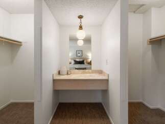 Discover a functional dressing area with ample closet space on either side, perfect for organizing your wardrobe.
