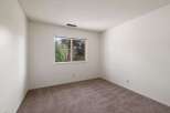 This spacious room features neutral carpeting and ample wall space, perfect for personalizing your living area.