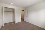 This spacious bedroom features a large closet with bi-fold doors, perfect for ample storage.