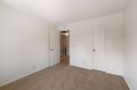 Step into this inviting room featuring plush carpeting and clean white walls, creating a serene atmosphere.
